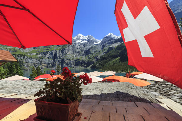Tourists relaxing at Lake  Oeschinensee Bernese Oberland Kandersteg Canton of Bern Switzerland Europe