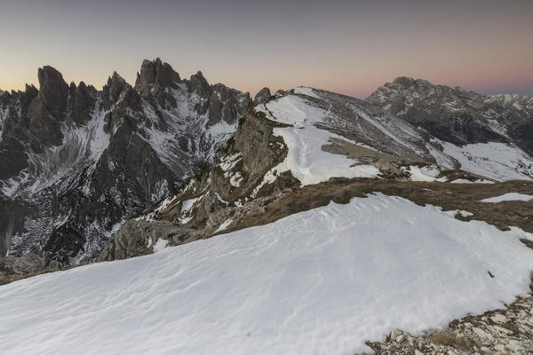 Pink sky at sunrise frames the Three Peaks of Lavaredo Dolomites Auronzo of Cadore Veneto Italy Europe