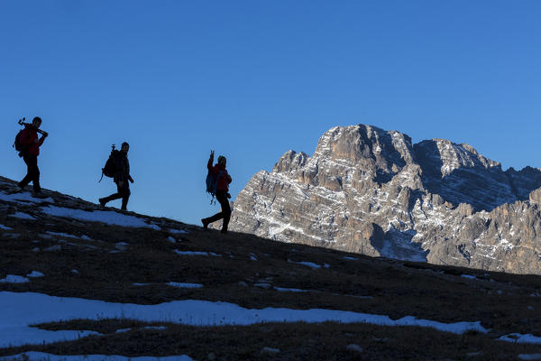 Hikers at sunrise Three Peaks of Lavaredo Dolomites Auronzo of Cadore Veneto Italy Europe