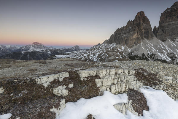 Pink sky at sunrise frames the Three Peaks of Lavaredo Dolomites Auronzo of Cadore Veneto Italy Europe