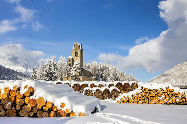 The church of San Gian surrounded by snowy woods Celerina Canton of Grisons Engadine Switzerland Europe