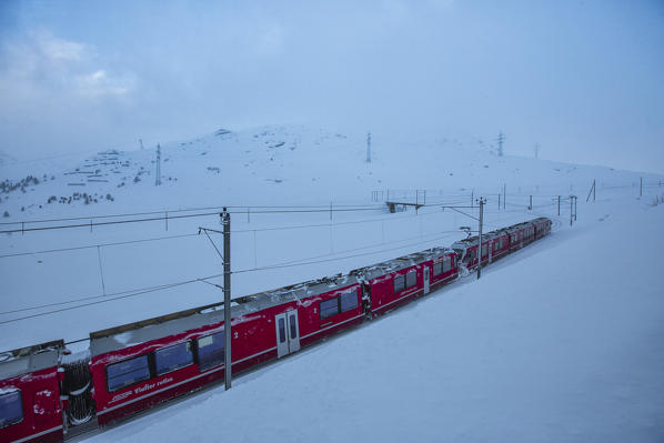 Bernina Express train at Bernina Pass Canton of Grisons Switzerland Europe