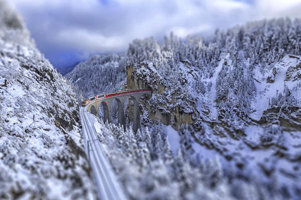 Bernina Express passes on Landwasser Viaduct around Filisur Canton of Grisons Switzerland Europe