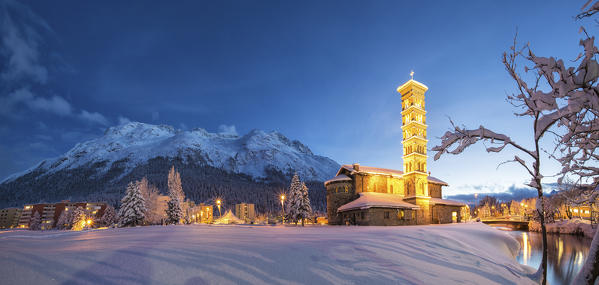 Dusk and lights on the church surrounded by snow Sankt Moritz Canton of Grisons Engadine Switzerland Europe