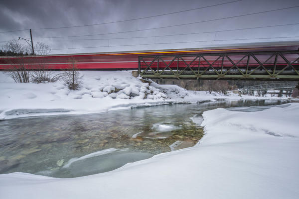 Bernina Express surrounded by snowy landscape Sankt Moritz Engadine Canton of Grisons Switzerland Europe