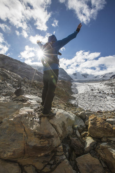 Hiker admires Forni Glacier Cedec Valley Stelvio National Park Valfurva Valtellina Lombardy Italy Europe