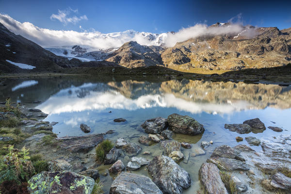 Sunrise reflections at Lake Rosole Forni Valley  Valfurva Valtellina Lombardy Italy Europe