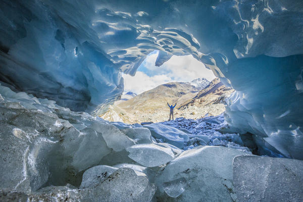 Hiker inside Forni Glacier Forni Valley Stelvio National Park Valfurva Valtellina Lombardy Italy Europe