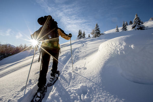 Snowshoe hiker walking in the snowy landscape Gerola Valley Valtellina Orobie Alps Lombardy Italy Europe