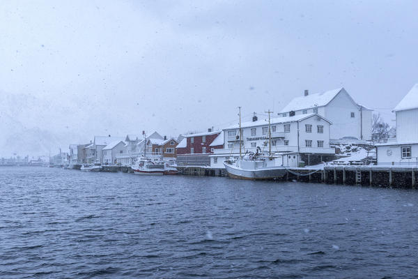 Heavy snowfall over the typical fishing village of Henningsvaer Lofoten Islands Northern Norway Europe
