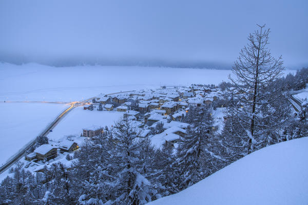 Heavy snowfall covered woods and villages Maloja Canton of Graubünden Engadine Switzerland Europe