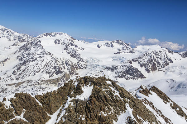 Aerial view of alpine skiers on peaks Dosegu and Mount Vioz Stelvio National Park Valtellina Valfurva Lombardy Italy Europe