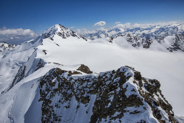 Aerial view of alpine skiers on peaks Dosegu and San Matteo Stelvio National Park Valtellina Valfurva Lombardy Italy Europe