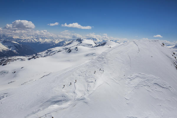 Aerial view of Forni Glacier and alpine skiers on Mount Cevedale Valtellina Lombardy Italy Europe