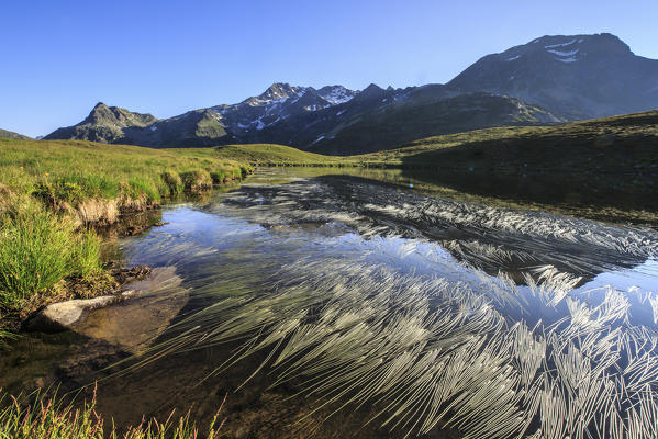 Peaks Suretta and Spadolazzo are reflected in Lake Andossi at sunrise Chiavenna Valley Valtellina Lombardy Italy Europe
