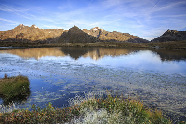 Mount Cardine and Peak Tambò are reflected in Lake Andossi at sunrise Chiavenna Valley Valtellina Lombardy Italy Europe