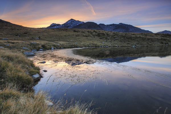 Peak Emet reflected in Lake Andossi at sunrise Chiavenna Valley Valtellina Lombardy Italy Europe