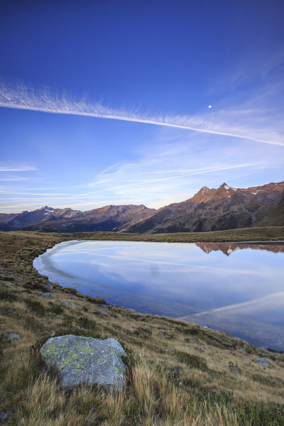 Peak Ferrè reflected in Lake Andossi at sunrise Chiavenna Valley Valtellina Lombardy Italy Europe