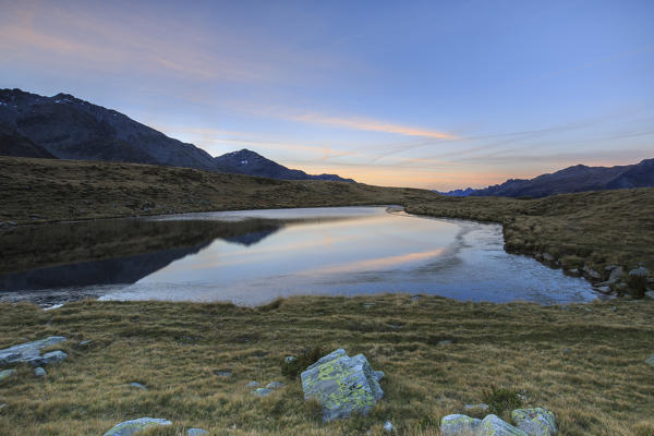 Autumnal view of Lake Andossi at sunrise Chiavenna Valley Spluga Valley Valtellina Lombardy Italy Europe