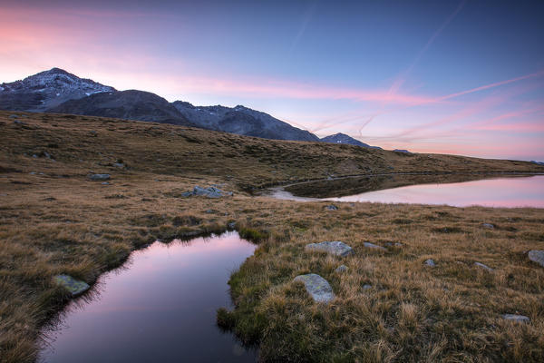 Peak Emet reflected in Lake Andossi at sunrise Chiavenna Valley Valtellina Lombardy Italy Europe