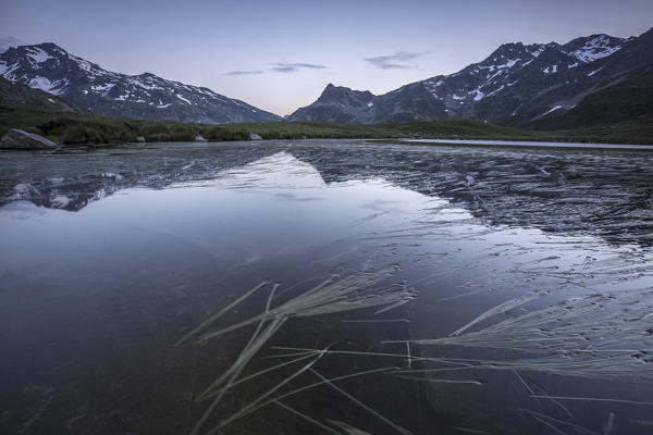 Peak Suretta reflected in Lake Andossi at dusk Chiavenna Valley Spluga Valley Valtellina Lombardy Italy Europe