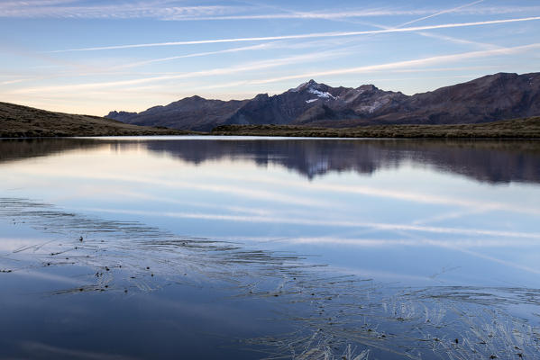 Peaks Tambò and Piani are reflected in Lake Andossi at sunrise Chiavenna Valley Valtellina Lombardy Italy Europe