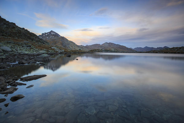 Peak Tambò reflected in Lake Bergsee at dusk Chiavenna Valley Spluga Valley Switzerland Europe