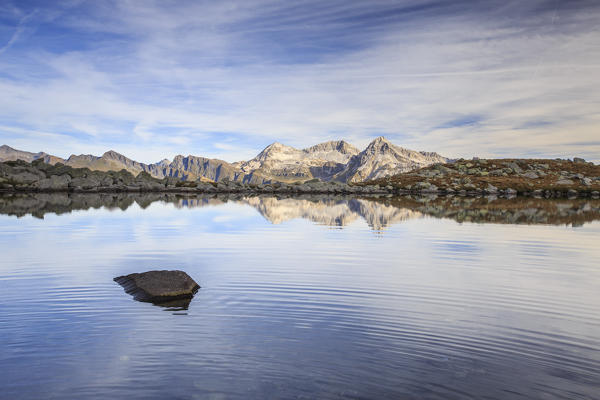 Peaks are reflected in Lake Bergsee at dawn Chiavenna Valley Spluga Valley Switzerland Europe