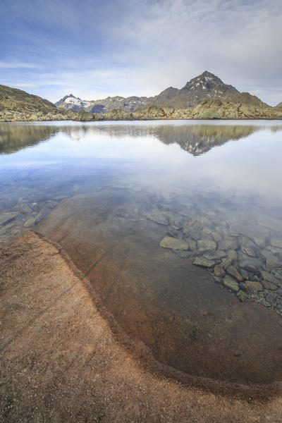 Peak Tambò reflected in Laghi Azzurri at sunrise Chiavenna Valley Spluga Valley Valtellina Lombardy Italy Europe