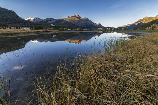 Dawn illuminates the autumn landscape and Lake Sils Engadine Canton of Graubünden Switzerland Europe