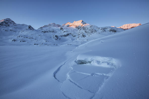 Sunrise light up the snowy landscape at Bernina Pass Engadine Canton of Graubünden Switzerland Europe