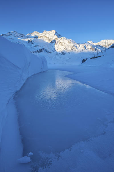 Sunrise light up the snowy landscape at Bernina Pass Engadine Canton of Graubünden Switzerland Europe