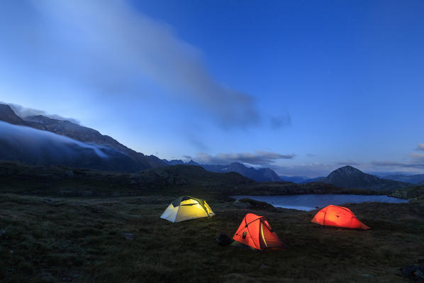 The soft lights of the tents light up dusk Minor Valley High Valtellina Livigno Lombardy Italy Europe