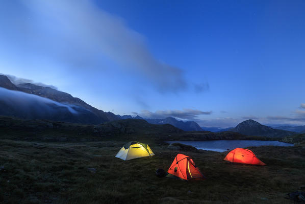 The soft lights of the tents light up dusk Minor Valley High Valtellina Livigno Lombardy Italy Europe