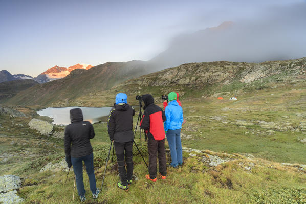 Photographers in action at dawn Minor Valley High Valtellina Livigno Lombardy Italy Europe