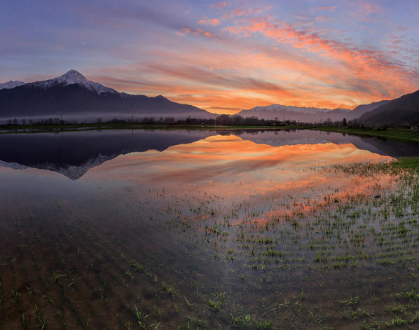 Panoramic view of Pian di Spagna flooded with Mount Legnone reflected in the water at sunset Valtellina Lombardy Italy Europe