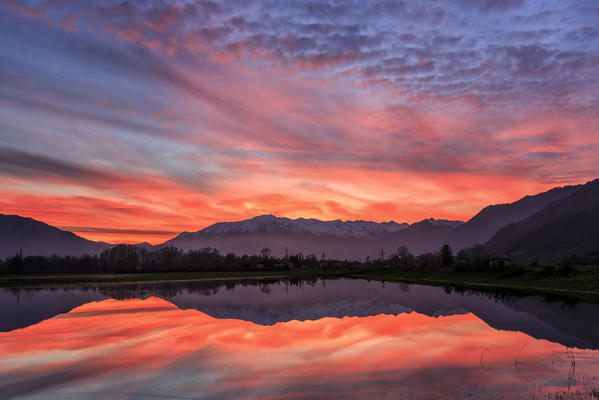 Natural reserve of Pian di Spagna  flooded with snowy peaks reflected in the water at sunset  Valtellina Lombardy Italy Europe