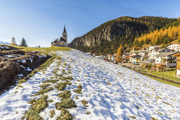 The church of Schmitten surrounded by colorful woods and snow Albula District Canton of Graubünden Switzerland Europe
