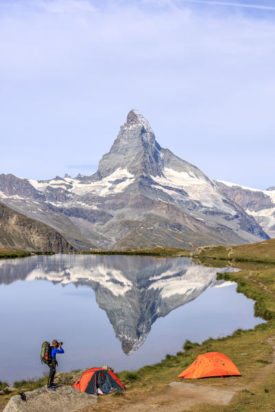 Photographer in action with Matterhorn reflected in Lake Stellisee Zermatt Pennine Alps Canton of Valais Switzerland Europe