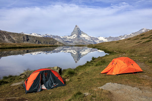 Tents of hikers on the shore of Lake Stellisee where the Matterhorn is reflected Zermatt Canton of Valais Switzerland Europe