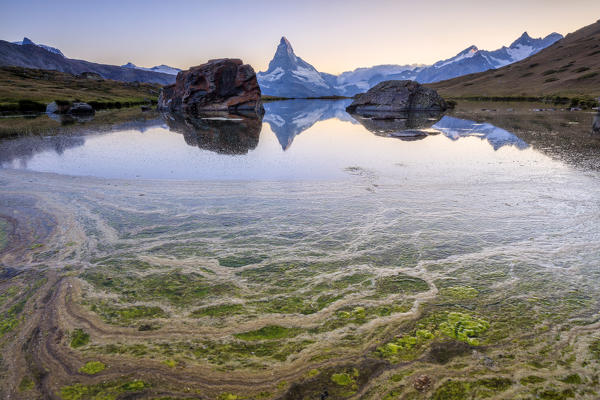 The Matterhorn reflected in Lake Stellisee at dawn Zermatt Pennine Alps Canton of Valais Switzerland Europe