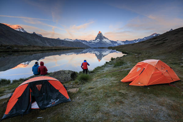 Photographer in action with Matterhorn reflected in Lake Stellisee at dawn Zermatt Canton of Valais Switzerland Europe