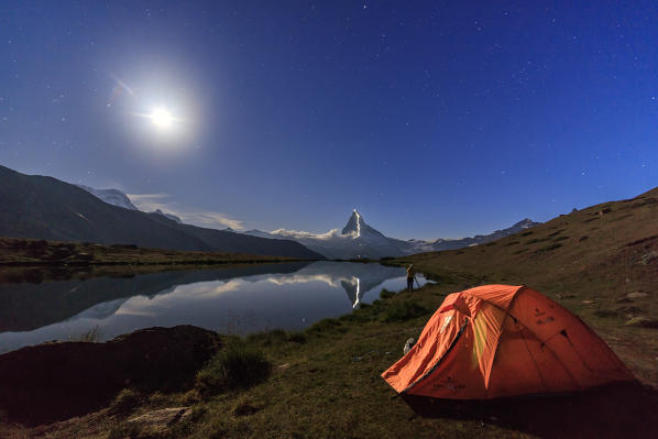 Camping under the stars and full moon with Matterhorn reflected in Lake Stellisee Zermatt Canton of Valais Switzerland Europe