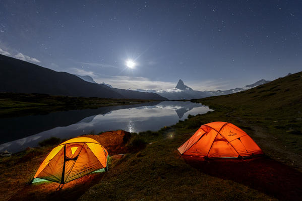 Camping under the stars and full moon with Matterhorn reflected in Lake Stellisee Zermatt Canton of Valais Switzerland Europe