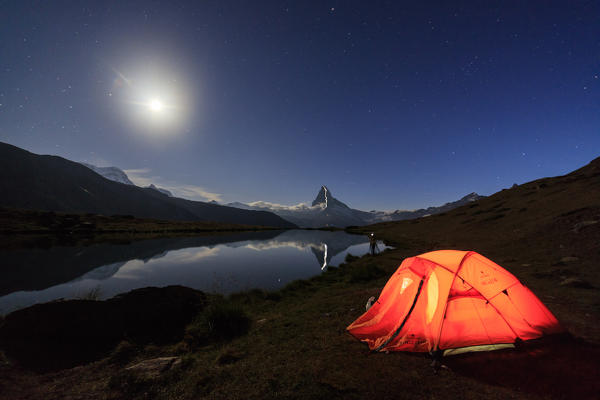 Camping under the stars and full moon with Matterhorn reflected in Lake Stellisee Zermatt Canton of Valais Switzerland Europe
