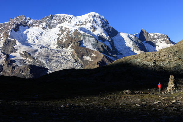 Hiker admires the snowy peaks of Breithorn Zermatt Canton of Valais Pennine Alps Switzerland Europe