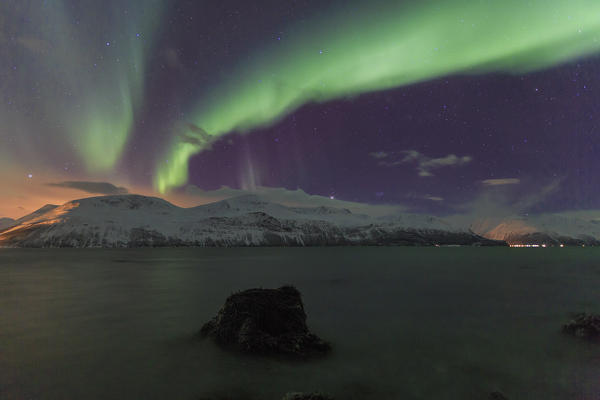 Northern Lights on the icy landscape of Svensby Lyngen Alps Tromsø Lapland Norway Europe