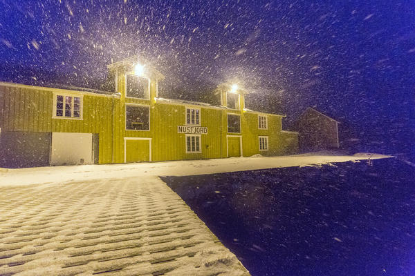 A blizzard hits the fishing village of Nusfjord at dusk Lofoten Islands Nordland County Norway Europe