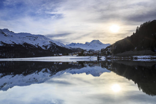 Snowy peaks and woods are reflected in the clear water Lake Silvaplana Maloja Canton of Graubünden Engadine Switzerland Europe