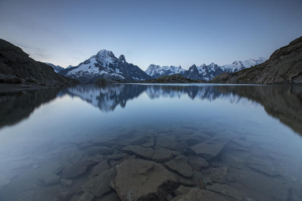 Snowy peaks of Grandes Jorasses reflected in Lac Blanc at dusk Chamonix Haute Savoie France Europe